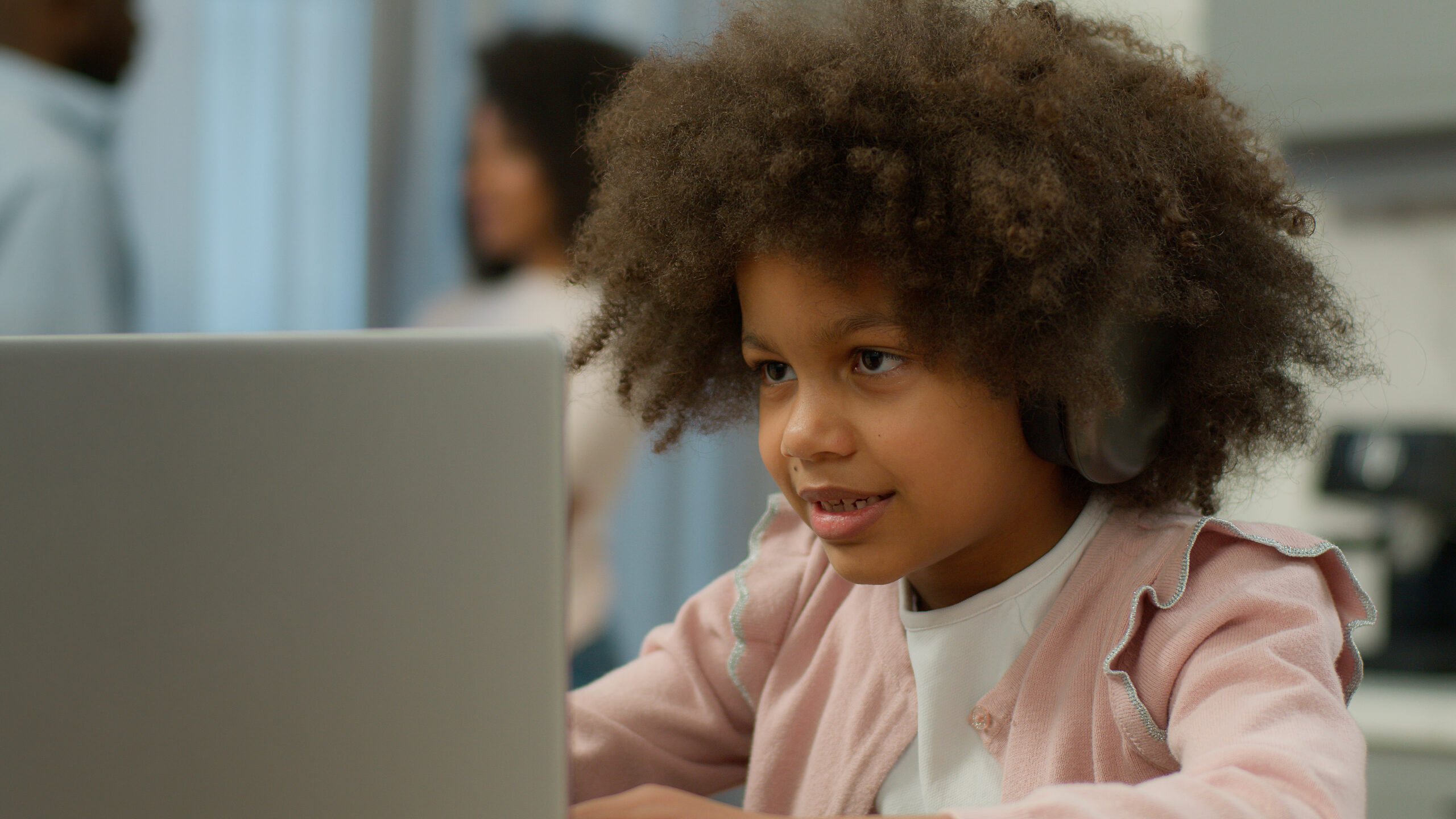 Child on laptop. This image displays the ten social emotional learning domains of VOISS.